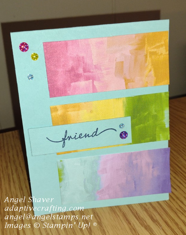 Light blue card with three strips of color representing the rainbow.  Card says "friend" and has several colors of glossy dot embellishments.
