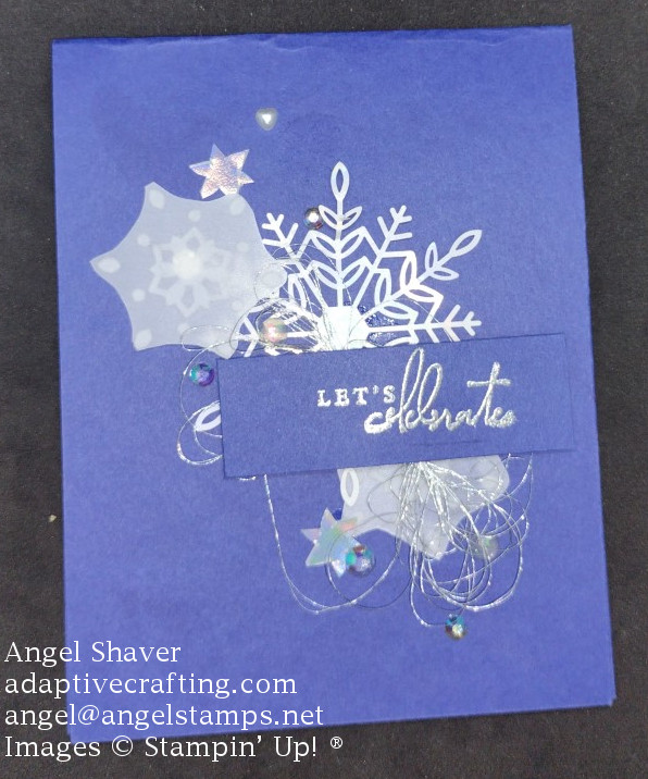Blue card with snowflakes and jewels scattered diagonally across the card.  "Let's Celebrate" is heat embossed in silver with loops of silver thread under sentiment rectangle.