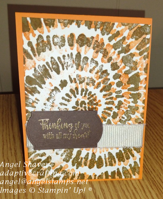 Orange card with spiral dye layer with orange and brown.  Sentiment is heat embossed in gold and "Thinking of you with all my heart."