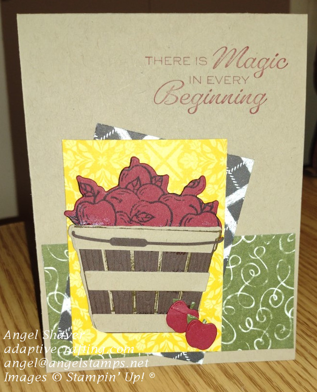 Crumb cake card with rectangles of patterned paper with diecut basket of apples on top.  Sentiment says, "There is Magic in Every Beginning."