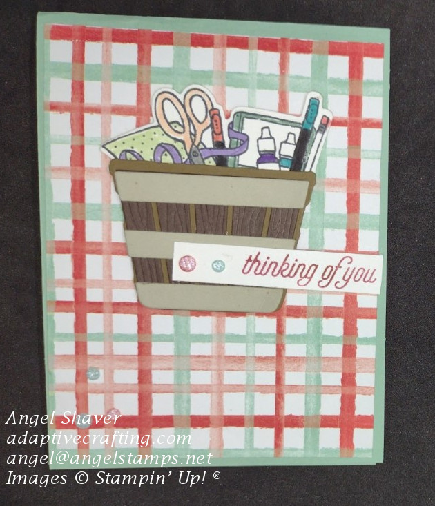 Thinking of you card with red and green plaid background.  Features die cut basket full of craft/school supplies.