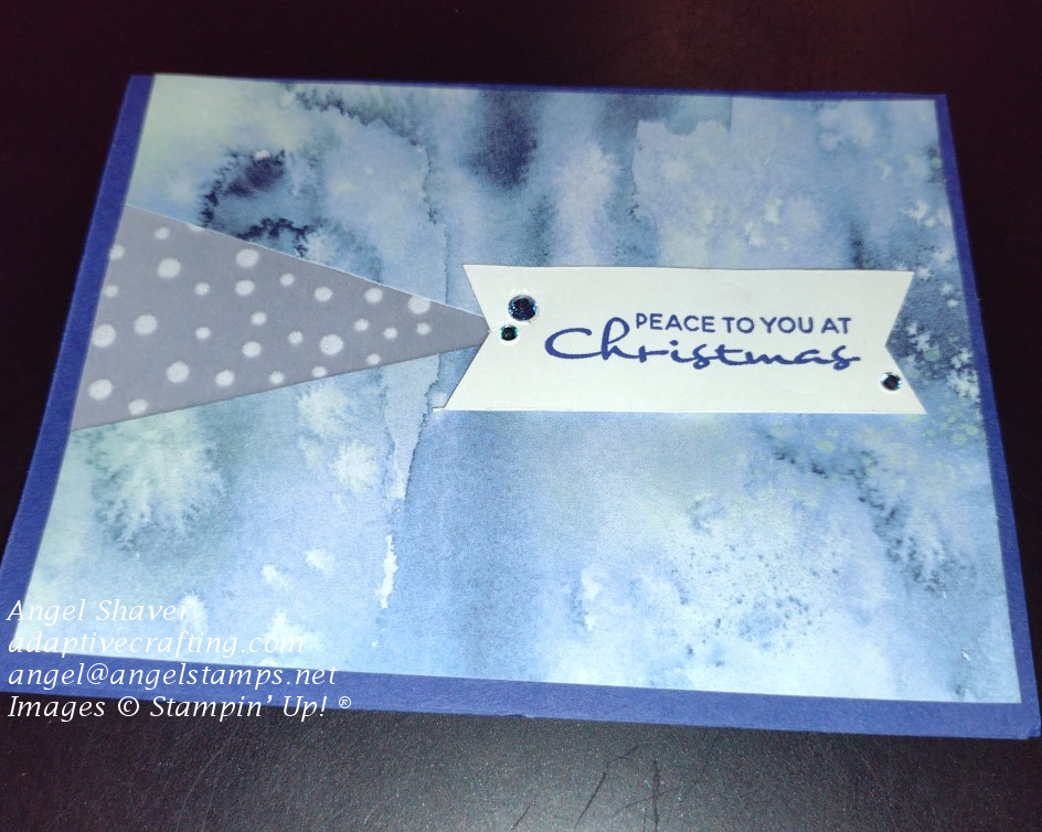 Blue Christmas card with patterned paper representing a snowfall.  Triangle of vellum continues this theme with white fuzzy balls reprenting falling snow. Card says "Peace to you at Christmas."
