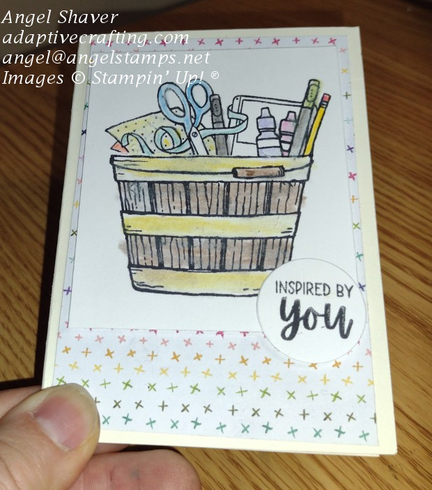 Simple notecard with stamped basket of craft supplies colored in with watercolor pencils.  Sentiment says "Inspired by you."