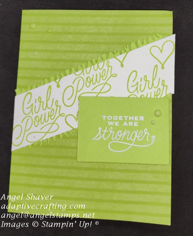 Green striped card monochromatic card with white diagonal strip stamped with "girl power." There is also a heat embossed sentiment that says, "Together we are stronger,"