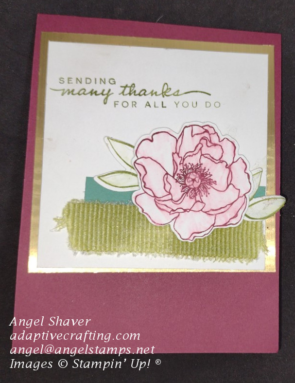 Thank you card with ribbon and strip of paper on square image with flower and leaf dies.  Card focal point image is framed with gold.  Sentiment say, "Sending thanks for all you do."