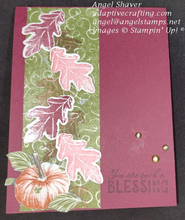 Reddish card with strip of green patterned paper on left side with both stamped and die cut fall leaves on paper and pumpkin at bottom of card.  Sentiment says "You're such a blessing."