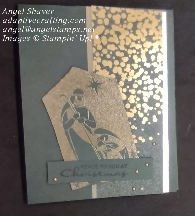 Green Christmas card with vertical strip of green sparkling paper with gold sparkles, framed in gold foil.  The holy family is heat embossed in gold on green paper.  Sentiment says "Peace to you at Christmas."