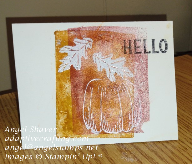 Simple fall hello harvest card. Yellow and rust colored background  with white heat embossed pumpkin and leaves.  Black "Hello" sentiment at top of card.