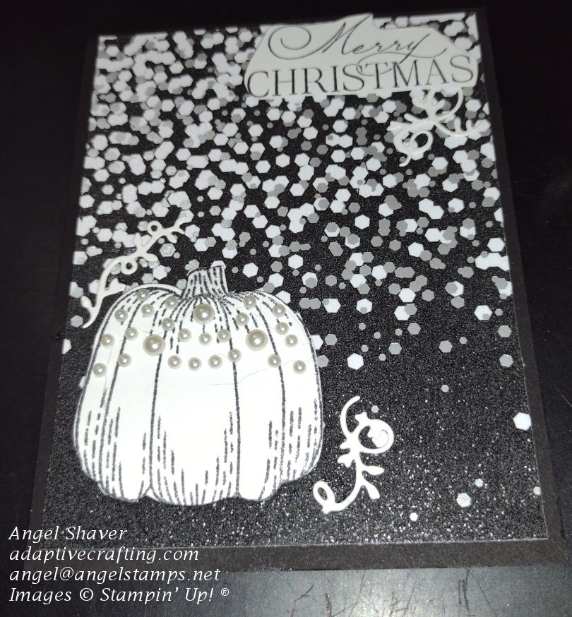Black Christmas card with white and silver sparkles and white pumpkin decorated with pearls. Sentiment says "merry Christmas."