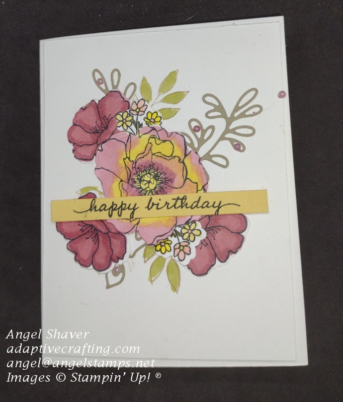 Birthday card with bouquet of flowers and leaves colored in with Stampin' Blends and Happy Birthday sentiment strip laying across bouquet.