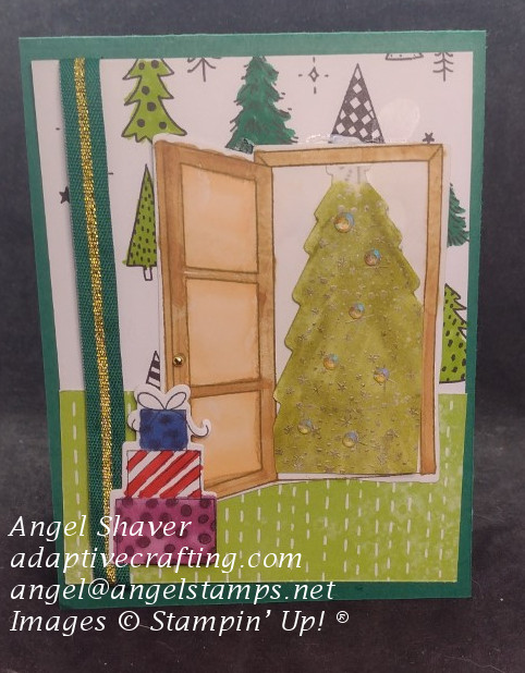 Green Christmas card with patterned paper featuring black and white and green trees.  Diecut door is open to reveal die cut Christmas tree heat embossed with gold decorations and stack of gifts outside the door.