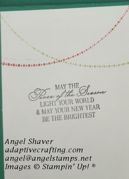 Inside of card with stamped red and green strings of Christmas lights and sentiment that says "May the Peace of the Season light your world & may your new year be the brightest."