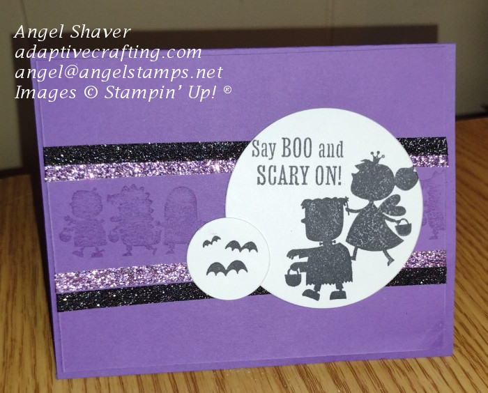 Purple Halloween card with monochrome stamped parade of trick or treaters.  Featured circle with trick or treaters.  Setiment says "Say Boo! and Scary On"