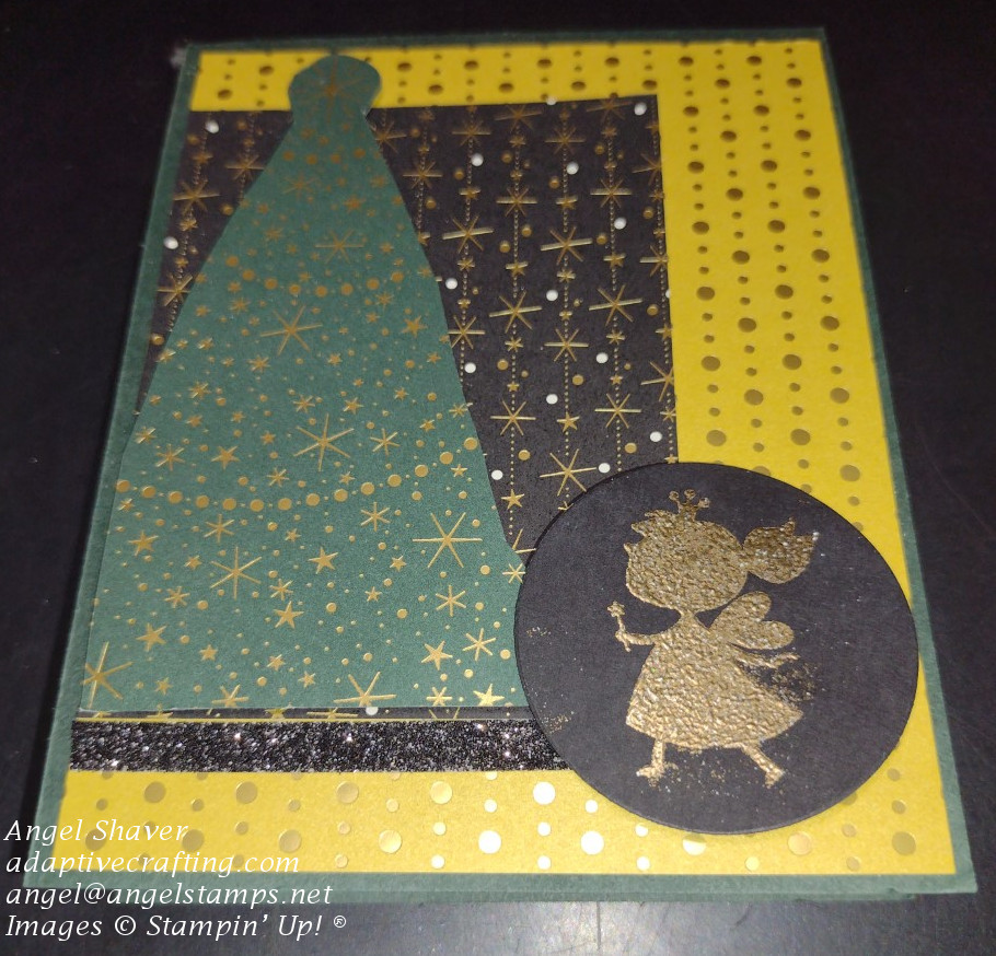 Green Christmas card with patterned paper with gold foil touches and a heat embossed gold fairy princess looking up at a Christmas tree.