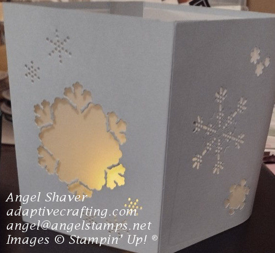 Light blue luminary with snowflake diecuts covered in vellum