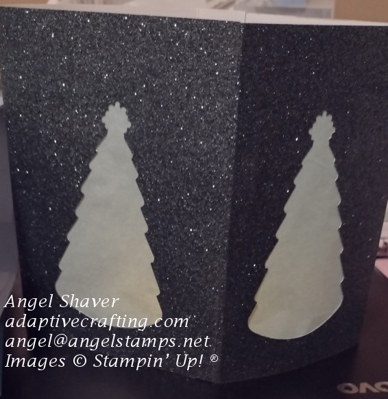 Dark green glimmer paper luminary with Christmas tree die cut covered in cotton paper