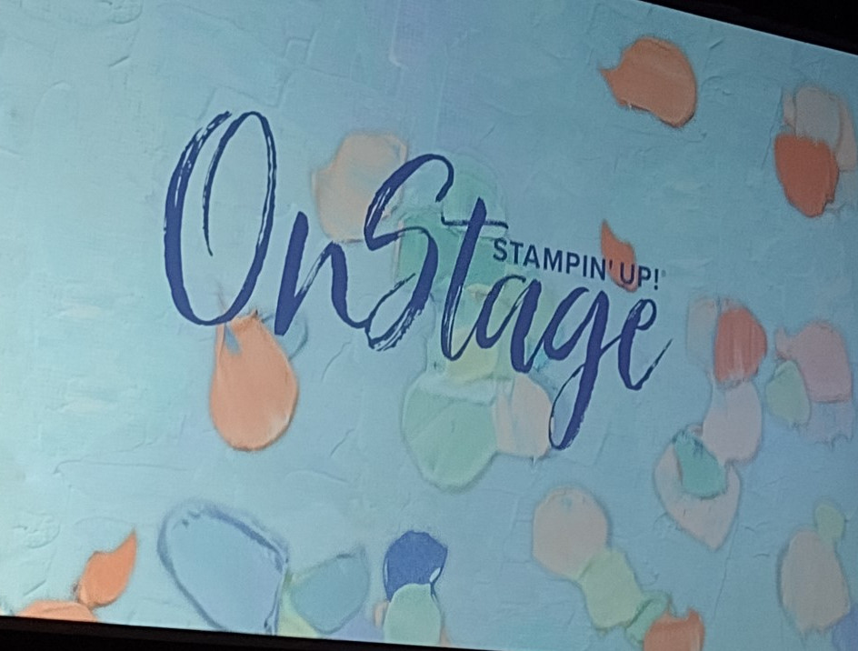 Stampin' Up@ Onstage light blue sign with sploshes of pastel colored paint