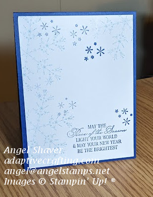 Blue Christmas card with blue snowflakes stamped on white card front.  Sentiment says, "May the Peace of the Season light your world & may your new year be the brightest."