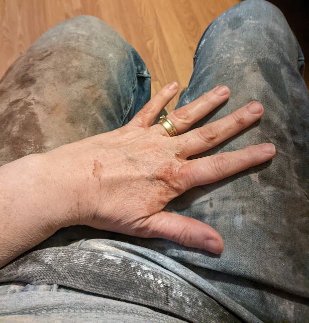 photo of my hand and jeans covered in spilled mess from ingredients used to make hot chocolate mix.