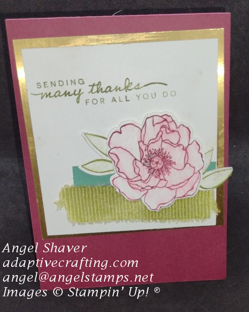 Thank you card with ribbon and strip of paper on square image with flower and leaf dies.  Card focal point image is framed with gold.  Sentiment say, "Sending thanks for all you do."