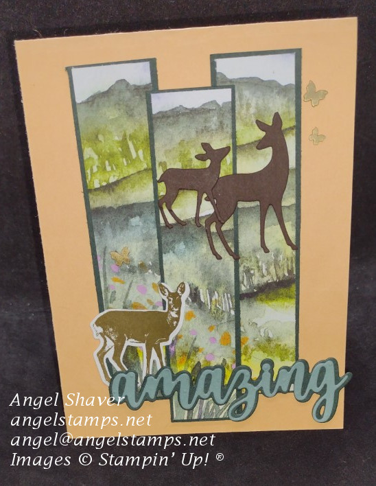 Peach card with three panels of grassy landscape framed in green.   Three Deer dies on landscape along with brass butterflies.  Sentiment dies of "amazing."