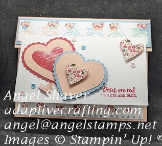 Pink card with a small fold down flap with patterned paper with bicycles.  White rectangle attached to front with layered hearts and sequins.  Sentiment says "Roses are red. Violets are blue."