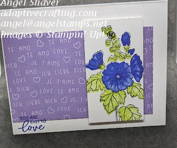 White card with strip of purple patterned paper with I love you written in several languages.  White rectangle with stamped floral image on top.  Sentiment says, "You are easy to love."