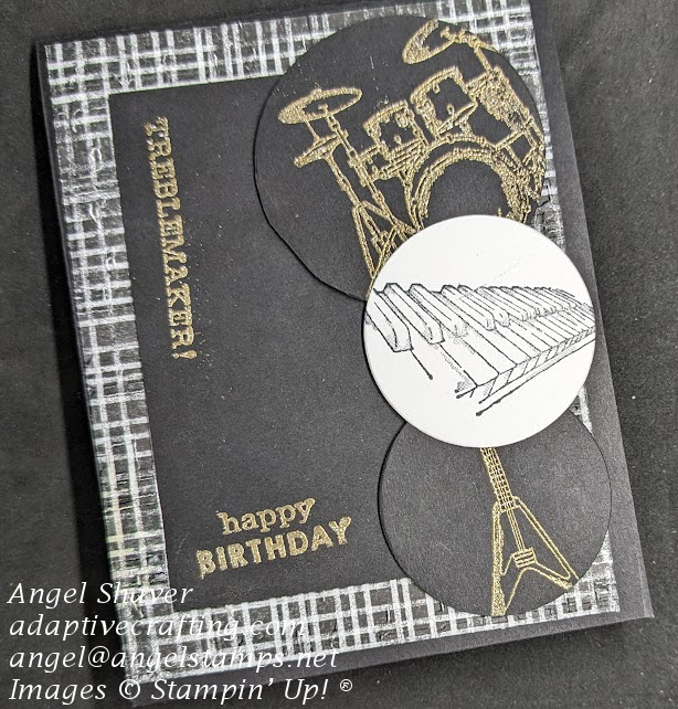 Black birthday card with black and white plaid patterned paper embossed with music.  Black rectangle layered on top with gold heat embossed "Treblemaker" and "Happy Birthday"  Stamped instrument circles on right side of card front.  Gold heat embossed drum set and bass guitar.  Black on white stamped keyboard.