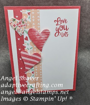 Red card with white front layer with strips of patterned paper with hearts.  Three hearts positioned on top of the paper strips.  Sentiment says "Love you lots."