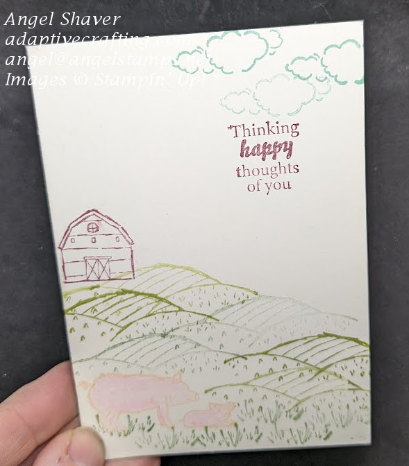 White notecard with farm scene stamped with barn, rolling hills, and pigs.  Sentiment says "Thinking happy thoughts of you."
