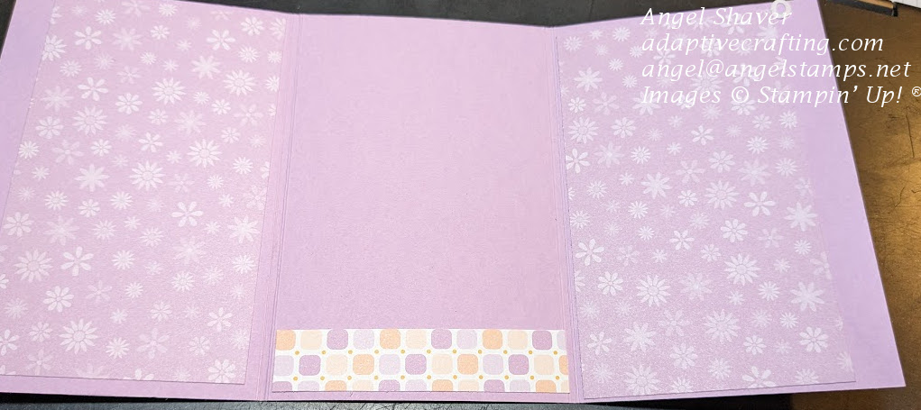 Open purple card with patterned paper with purple flowers.