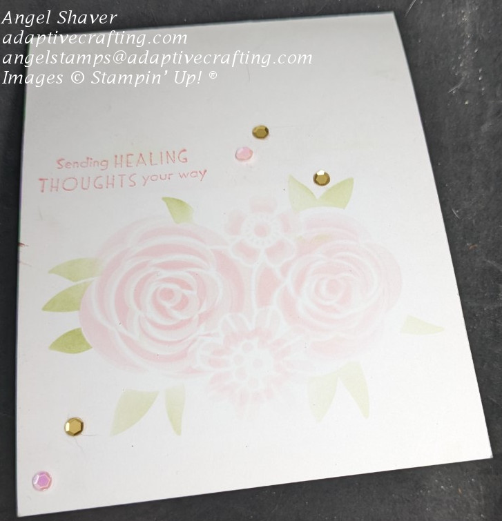 White card with pink roses with green flowers added to card front with a blending brush and stencils.  Sentiment says, "Sending healing thoughts your way."  Pink and gold sequins finish the card.