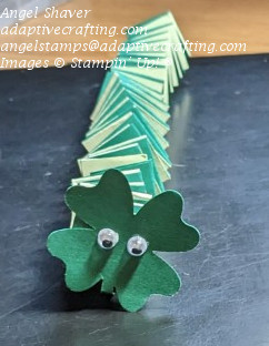 Paper snake made with two shades of green cardstock.  Head of snake is four-leaf clover punch with googly eyes.