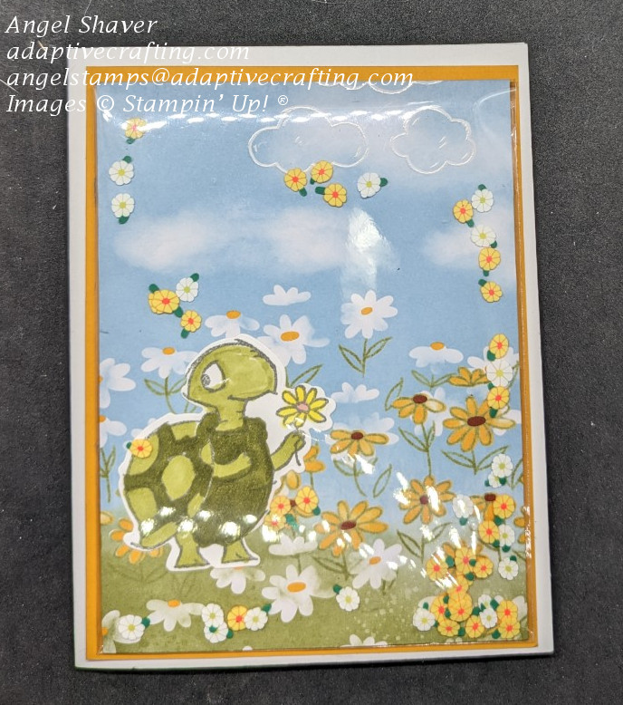 Spring shaker card with turtle standing in field of daisies.  Shaker elements are loose daisies.