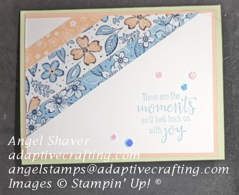 Light green card with white top piece with pink frame.  Diagonal strips of patterned paper in pink and blue with flowers and leaves across top left.  Sentiment says, "These are the moments we'll look back on with joy."  Pink and blue sequins finish the card.