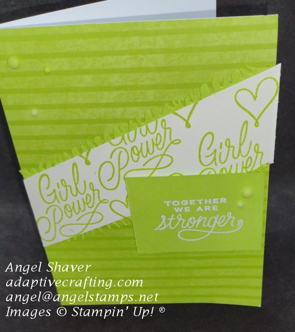 Green striped card monochromatic card with white diagonal strip stamped with "girl power." There is also a heat embossed sentiment that says, "Together we are stronger,"