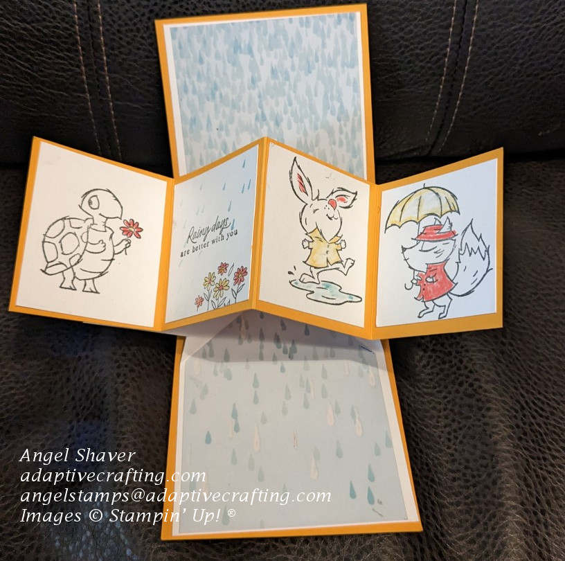 Inside of flip and twist card with patterned raindrop paper on inside of card.  Four panels on pop up mechanism with turtle, rabbit, fox and sentiment that says, "Rainy days are better with you.'