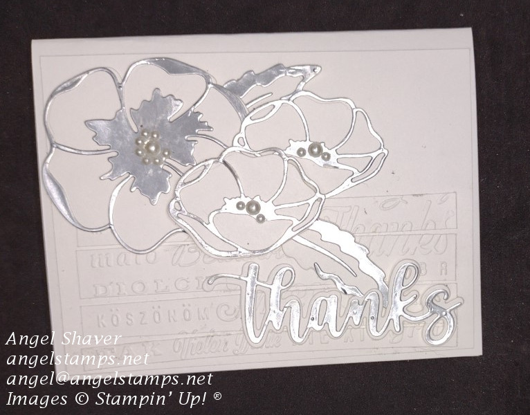 White on white card.  With embossed panels saying thanks in different languages.   Poppies are diecut in silver with pearl accents.  "Thanks sentiment is diecut in silver and white.