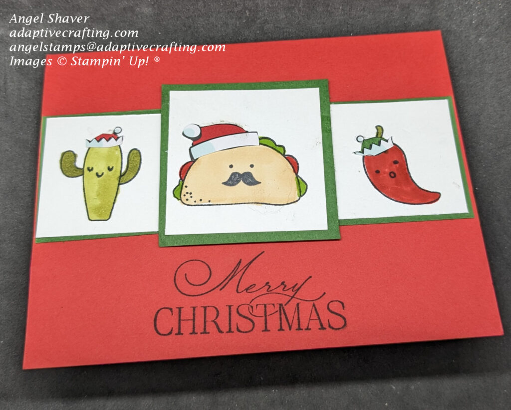 Red Christmas card with three stamped characters on white paper squares framed in green.  Characters are a cactus colored green wearing a red elf hat, a taco with a moustache wearing a Santa hat, and a red pepper wearing a green elf hat.  All characters have stamped faces.  The sentiment says 'merry Christmas."
