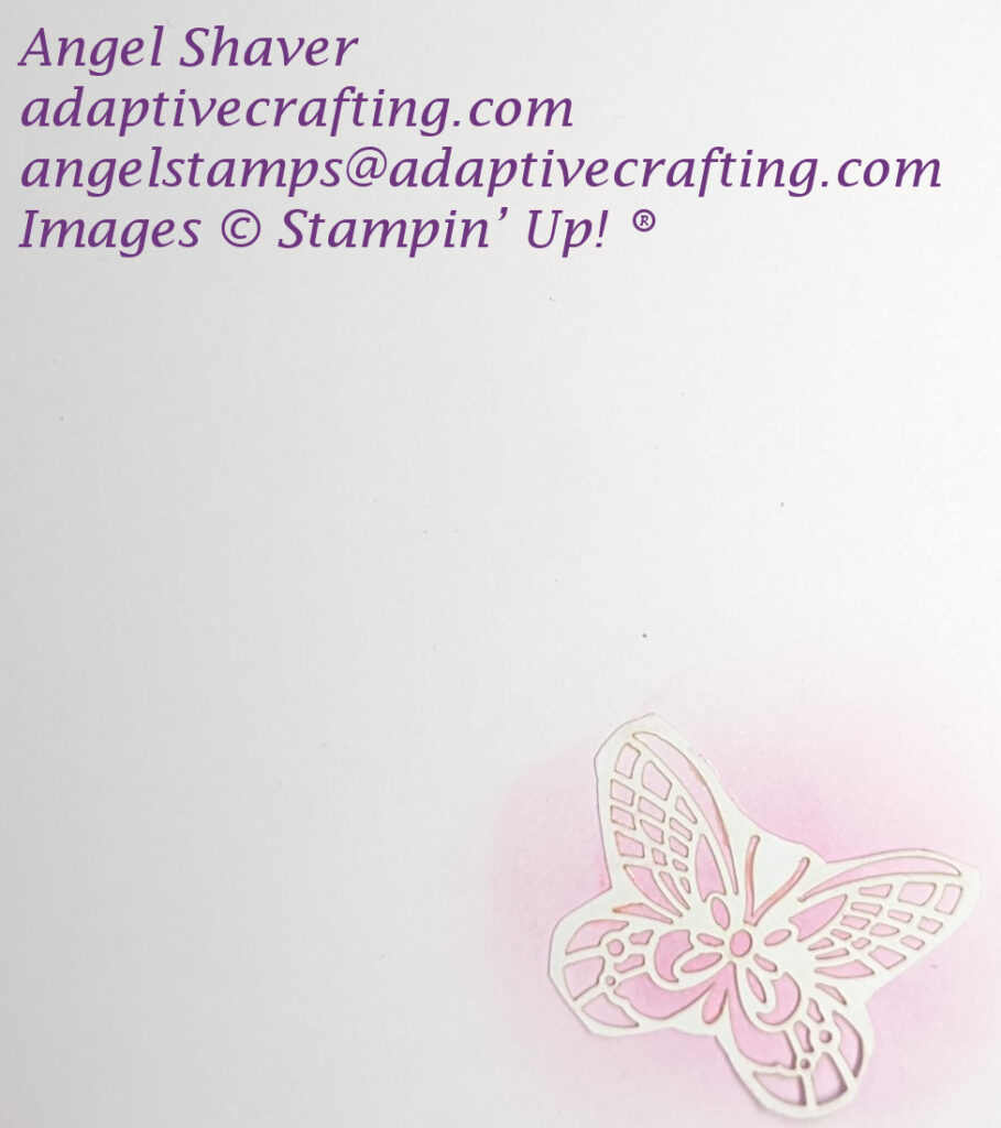 Inside of card with cut out white butterfly on top of pink ink splotch.