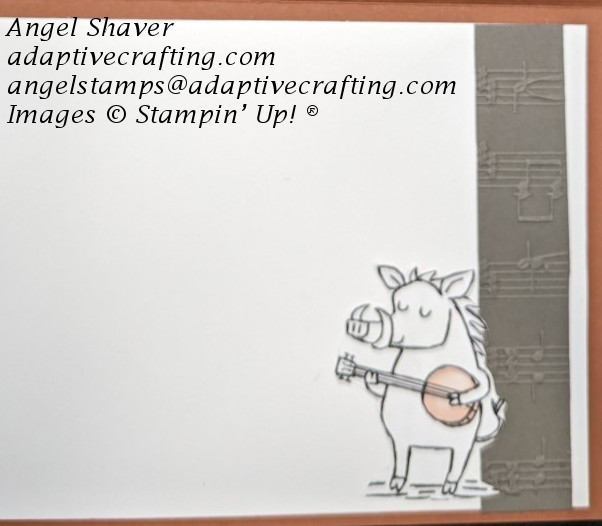 Inside of card with strip of gray music embossed cardstock on right side of card interior.  There is also a paper image of a wild hog playing a bango.
