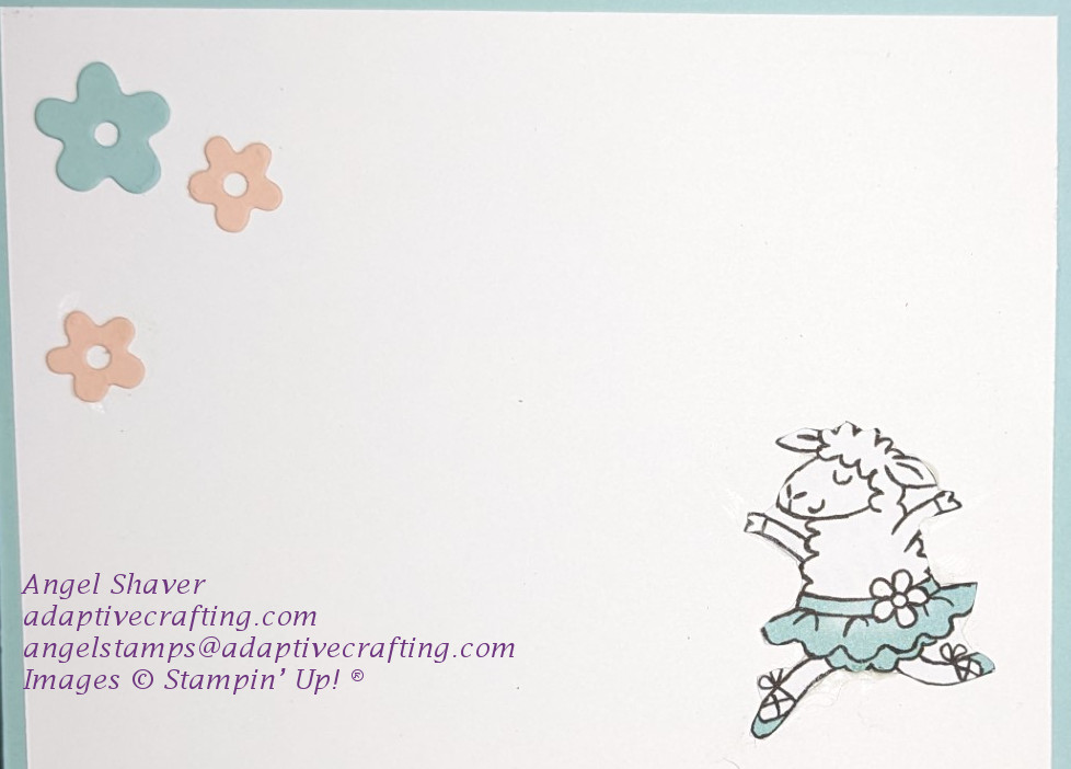 Inside of card with pink and blue flower dies on upper left corner and dancing sheep diecut on bottom right.
