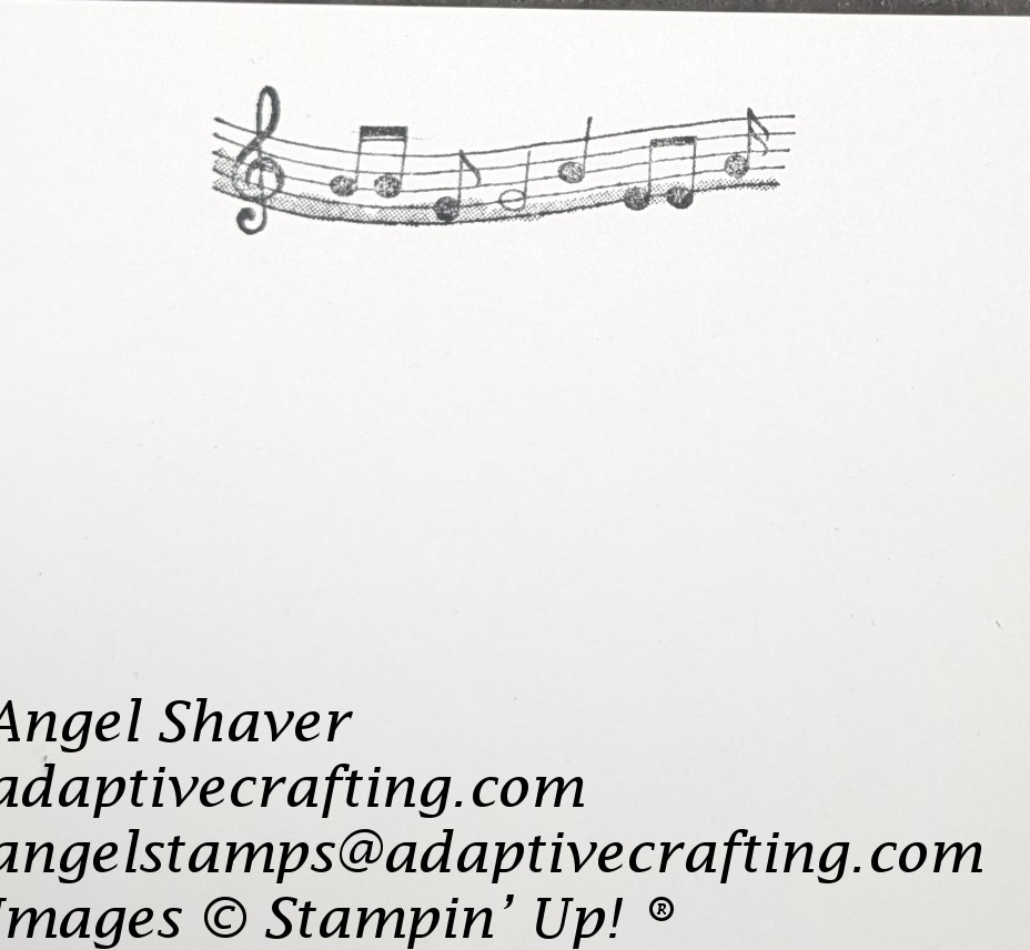 White card interior with treble clef music staff stamped with black ink