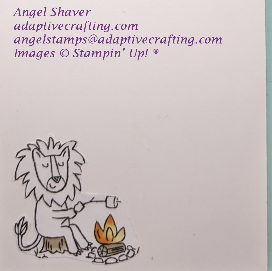 Inside of card with lion roasting a marshmellow over a campfire.