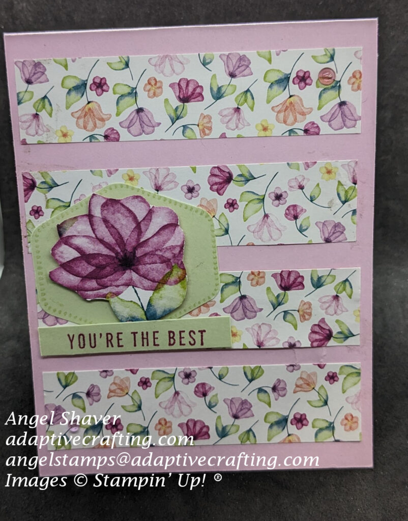 Pink card with four horizontal panels of  pattern paper with small flowers.  On top of that is light green hexicon punch with a flower fussy cut from patterned paper.  Sentiment label says, "You're the Best."