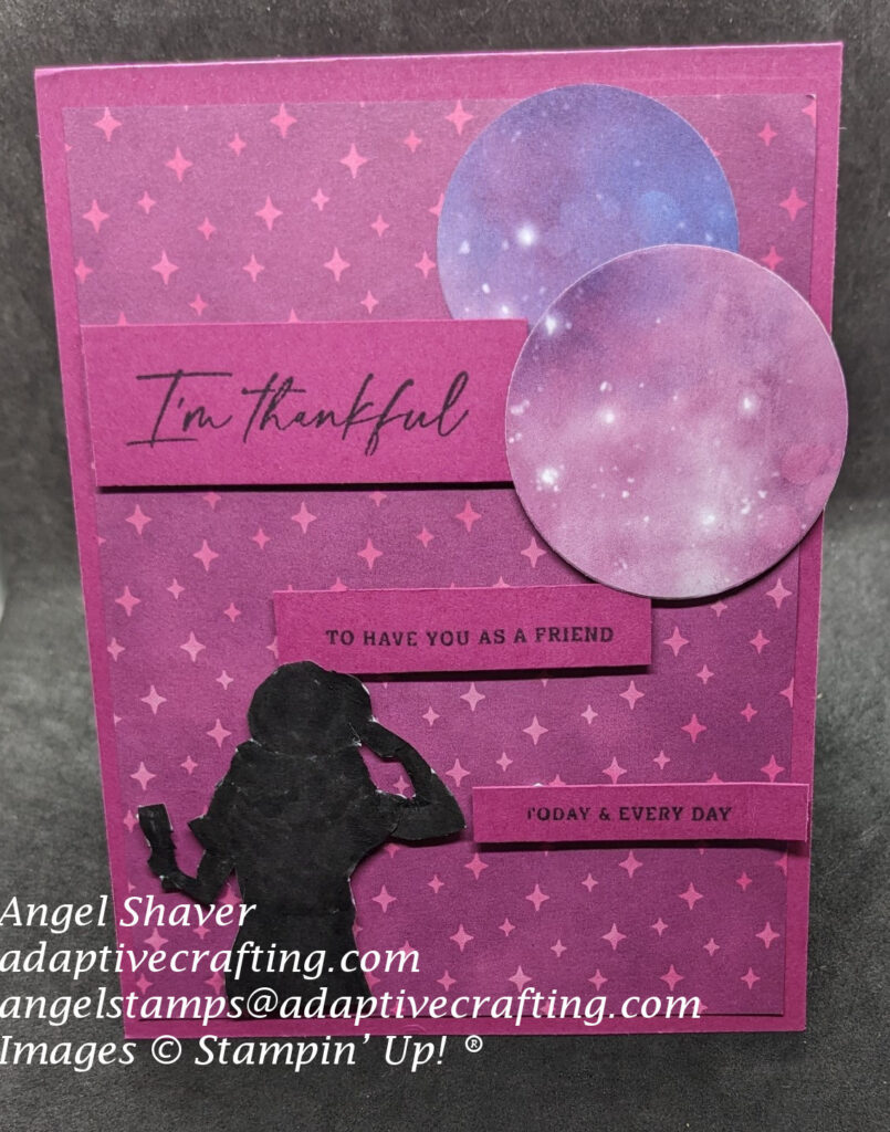 Pink card with silhouette of woman looking up to the sky. Circle dies with colorful starry sky are at top right of card.  Sentiment is in three labels diagonal across card and says, "I'm thankful", "to have you as a friends", "today and every day"