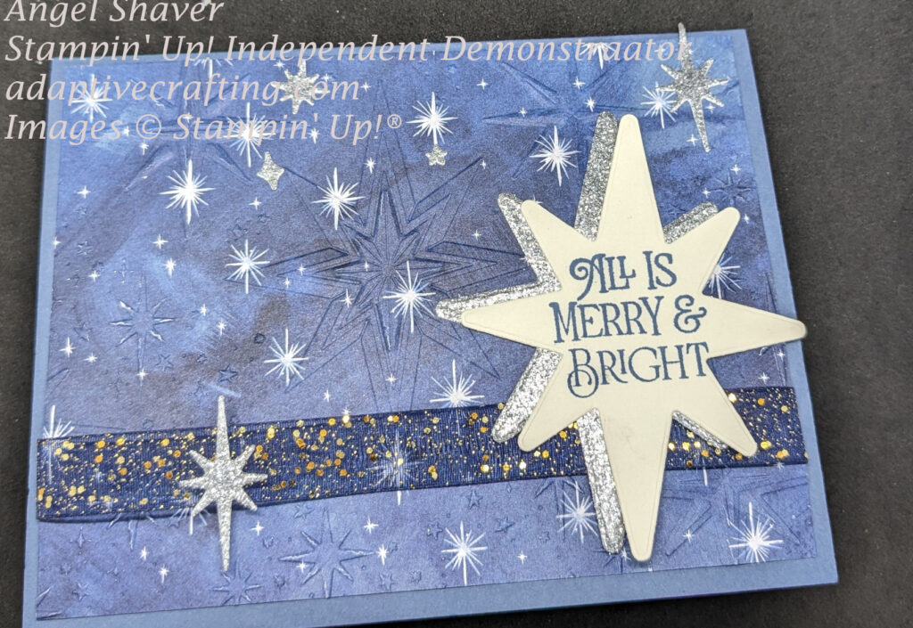 Blue Christmas card featuring a star patterned paper, embossed with star embossing folder, and die cut silver stars added.  The top star has the sentiment, "All Is Merry & Bright."