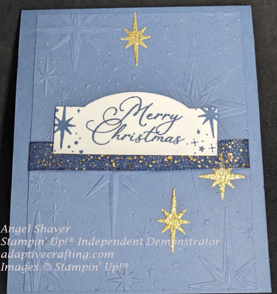 Blue Christmas card made featuring a night sky card front layer with embossed stars and gold glimmer die cut stars.  The sentiment label says, "Merry Christmas" with stamped stars.
