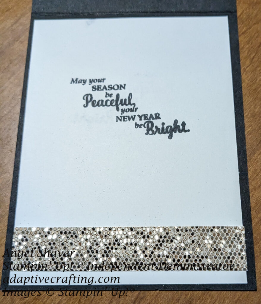 White inside of card with strip of sparkling sequined paper along bottom edge and sentiment that says, "May your season be peaceful and may your new year be bright."