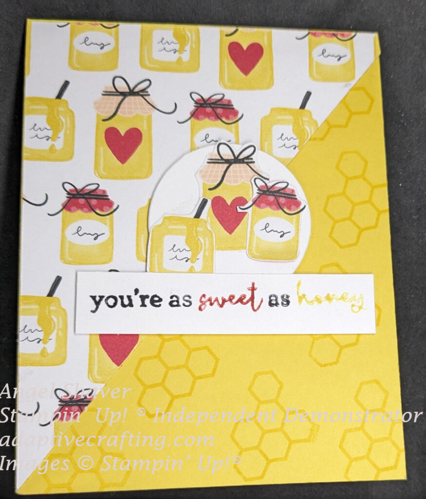 Yellow card with honeycomb stamped on bottom right diagonal and patterned paper with honey jars on top left diagonal of card front.  Three individual honey jars are featured in center circle.  Sentiment says, "you're sweet as honey."